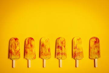 isolated delicious yellow-red ice cream on a colorful summer background
