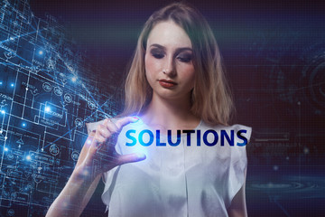 The concept of business, technology, the Internet and the network. A young entrepreneur working on a virtual screen of the future and sees the inscription: Solutions