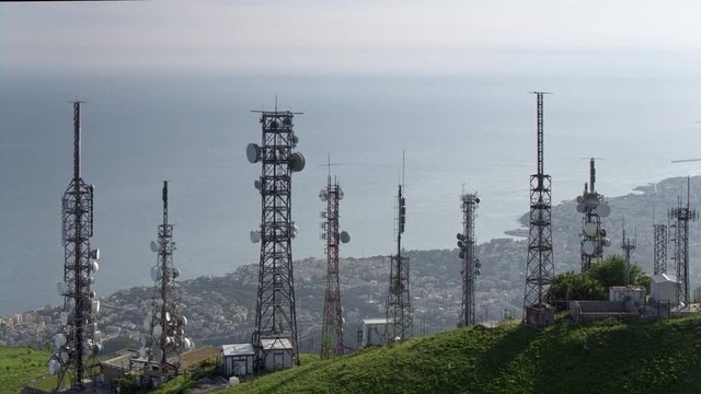 aerial view of telecom antennas telecommunications towers with cityscape in the background