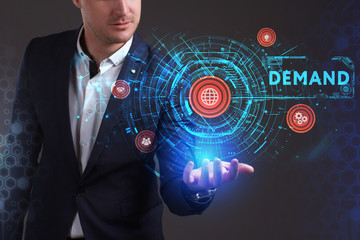 Business, Technology, Internet and network concept. Young businessman working on a virtual screen of the future and sees the inscription: Demand