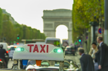 taxi car sign and business people. Arc de Triomphe in background, Paris city