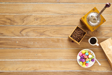 Morning coffee on wooden with macarons biscuit