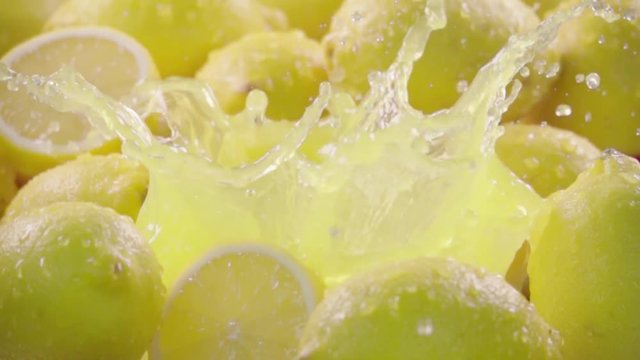 Lemon falling in juice with splash between lemons. Slow motion 480 fps. Sony rx10 4