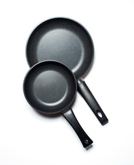 Two new frying pans, isolated on a white background.