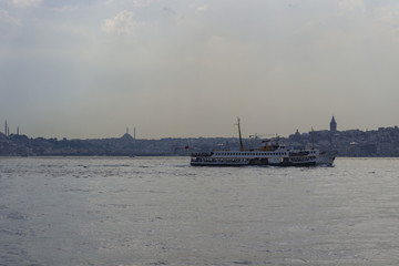 Fototapeta premium Steamboat with galata tower and city istanbul background.