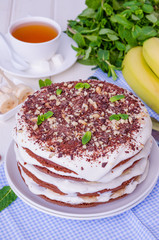 Chocolate cake with cream and bananas. Rustic style
