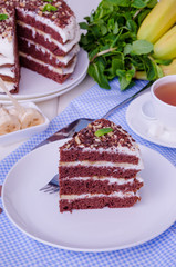 Chocolate cake with cream and bananas. Rustic style