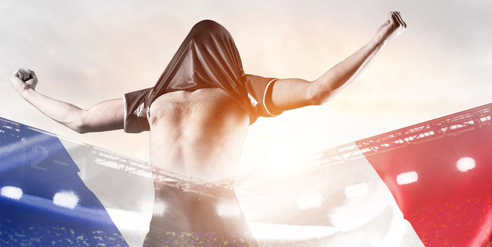 France national team. Double exposure photo of stadium and soccer or football player celebrating goal with his jersey on head