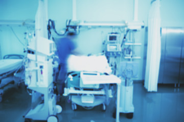 Male nurse on duty at the bedside of the patient, unfocused background
