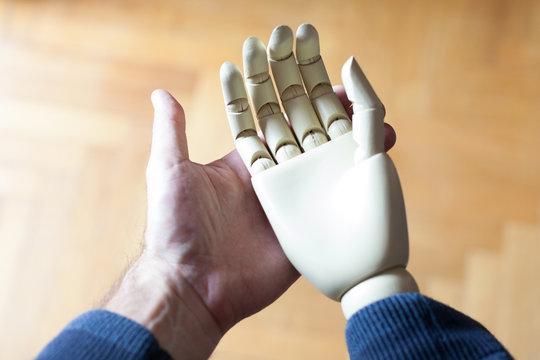 Real Hand Holding Prosthetic Hand
