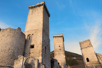 Towers and rampart of Pacentro castle at sunset (Italy)