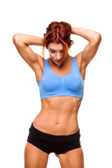 Fototapeta na wymiar Muscular young woman athlete standing on white background. Woman bodybuilder relaxing after exercise.