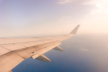 Naklejka na ściany i meble view from the airplane window, ocean blue, sunny day. Vacation concept