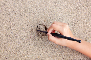 Child draws a stick on the sea with the sun. Children's drawing.