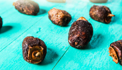 Dried persimmon - healthy raw dessert on a blue wooden background