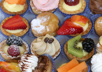 background of fruit and cream flavored pastries in a pastry shop
