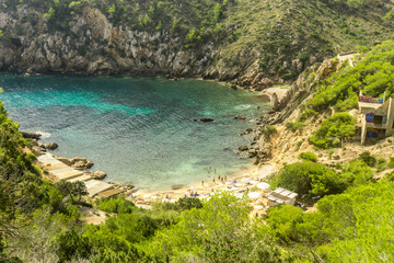 Ibiza, Spain, August 27, 2017: Ibiza natural beach view with some tourists during summer.