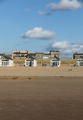   Row white beach houses at the Dutch coast in Katwijk, Netherlands