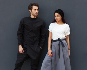 Beautiful young couple posing in a summer cool outfit. Youth street fashion.