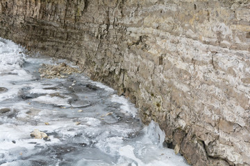 Frozen Stream against cliff