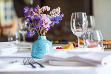 Beautiful flowers in vase with light from window
