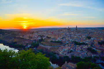 Fototapeta na wymiar Sunset at lookout of Toledo, Spain. Tajo river around the city and Alcazar and Cathedral at background.