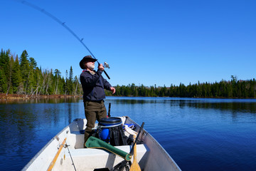  A peaceful caucasian man, 50's, wearing a white beard, a leather hat Australian style and a blue...