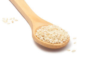 white sesame seeds in wooden spoon isolated on the white