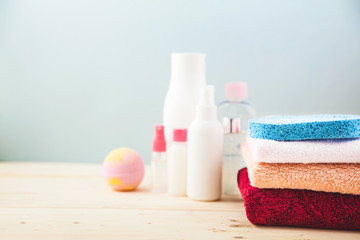 Obraz na płótnie Canvas bathroom accessories - towels. cream and shampoos on a light, bright background Concept of caring for yourself, your body Place for copy space