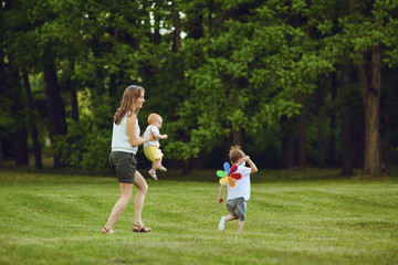 Mother with children in summer park. Mothers Day.