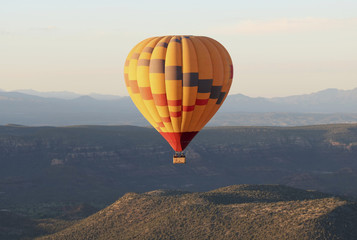 Fototapeta premium A Hot Air Balloon Soars Near Sedona, Arizona