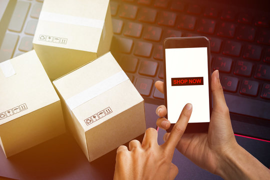 Online shopping concept e-commerce delivery buying service. square cartons shopping on laptop keyboard, showing customer order via the internet.