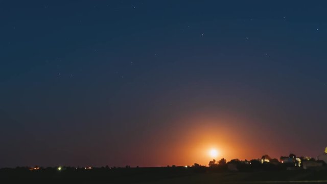 Time Lapse Time-lapse Timelapse Of Moonrise Above Belarusian Village In Eastern Europe. Belarusian House In Village Or Countryside Of Belarus In Summer Starry Night