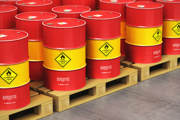 Group of red oil drums on shipping pallets in the storage warehouse