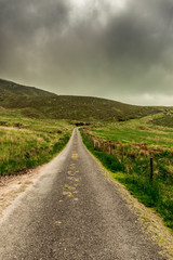 Fototapeta na wymiar Scenic roads at Caherconree, a 835 meter high mountain on the Dingle Peninsula in County Kerry, Ireland, the second-highest peak of the Slieve Mish Mountains.