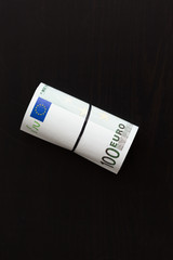 Roll of one hundred euro bills. Shallow dof