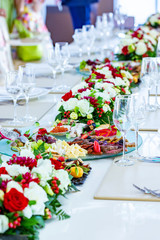 A beautiful banquet table with snacks and flowers on the table. Selective focus