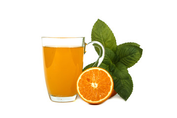 Fresh orange juice with mint in a glass cup isolated on white background. Fresh oranges and juice on a white background, view of the shu, cospore space.