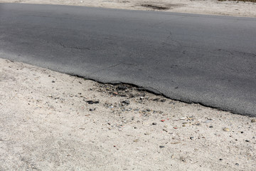 bad asphalt road, pit on the road