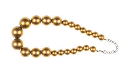 necklace of gold pearls on white isolated background