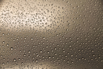 Rain drops on brown window glass , rainy day