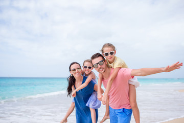 Fototapeta na wymiar Happy beautiful family on the beach