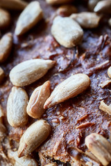 Close up picture of a whole wheat bread crust with sunflower seeds, selective focus.