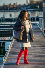 Woman in red overknee boots on a mooring at lake constance.