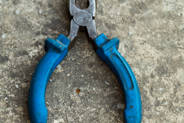 Top view of pliers with long noses and blue handle