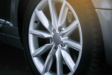 Close-up of aluminium rim of luxury car wheel. Detail background - obrazy, fototapety, plakaty