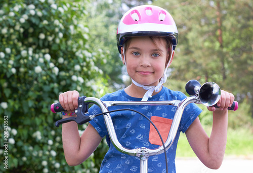 A Cute Baby On A Helmet On A Bicycle Stock Photo And Royalty Free
