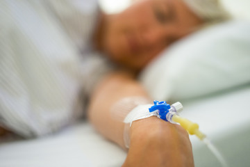 Peripheral venous catheter on the hand of young woman