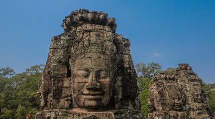Naklejka premium Angkor Temples, Siem Riep, Cambodia - February 12, 2018: Huge face sculpted in stone, exterior of the temple