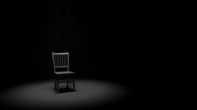 Metal Chair in a Spotlight in a Dark Black Room